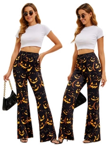 Detail of high-waist Halloween flared pants with orange pumpkin print and white crop top