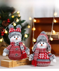 Close-up of plush Christmas snowman ornaments in knit hats with snowflake patterns