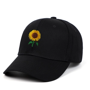 Close-up of a black cotton baseball cap with detailed sunflower embroidery on the front