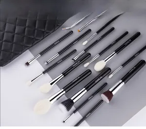 Detailed view of 15 professional makeup brushes with a black quilted cosmetics storage bag