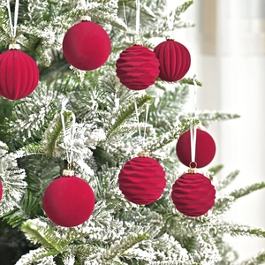 6cm burgundy velvet Christmas balls with mixed textures on a snow-covered tree branch