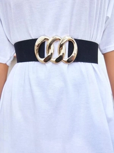 Close-up of a black elastic waist belt featuring a polished gold interlocking buckle