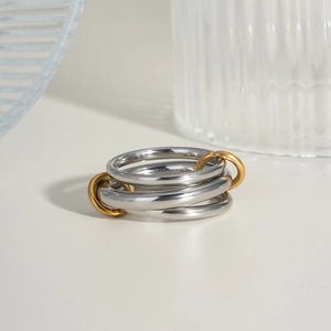 Polished silver and gold interconnected band rings in a modern minimalist style