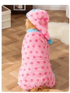 Detailed back view of large dog wearing pink polka dot fleece pajamas and matching hat