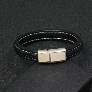 Close-up of black braided leather bracelet with a silver magnetic metal clasp