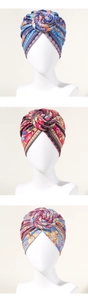 Detail of bohemian turban hats featuring 3D spiral flower knots and ethnic floral prints