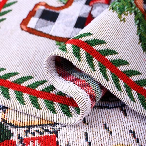 Macro shot of thick Christmas table mat fabric with festive pine and plaid jacquard texture