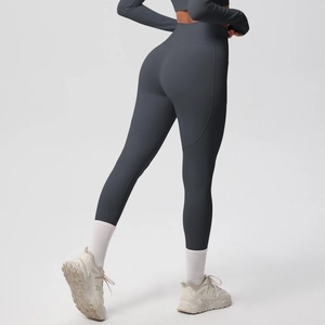 Detail view of high-waisted dark grey yoga pants with matte finish and sculpting seams