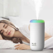 White mini humidifier with colorful LED light featuring ultra-quiet operation for sleeping