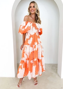 Detail of elegant orange floral off-shoulder dress with puff sleeves and layered skirt