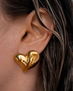 Close-up of a 18K gold-plated heart-shaped earring with a polished 3D puffy design