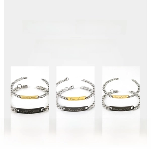 Detail of titanium steel couple bracelets with polished engraving and vacuum plating finish