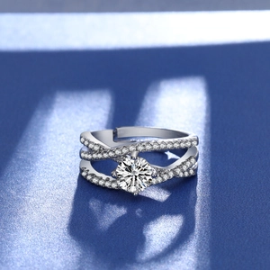 Close-up of sparkling one carat round-cut stone on a silver crossover ring band