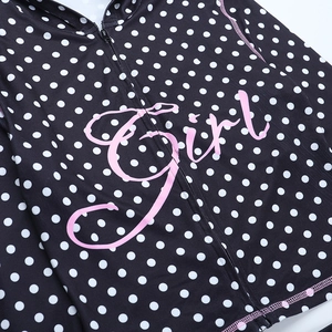 Detailed view of black polka dot zip-up hoodie with pink Girl printed text on fabric