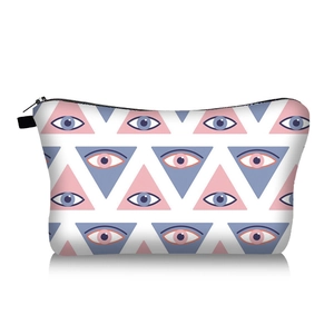 Close-up of evil eye pattern makeup bag with black zipper and reflective surface