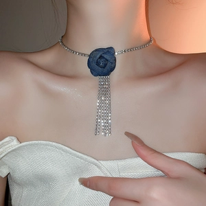 Detail of blue denim rose choker with elegant rhinestone fringe and sparkly chain