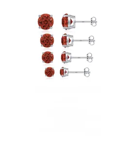 Macro detail of S925 sterling silver studs with four sizes of red gemstone in claw setting