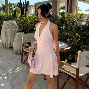 Pink halter neck mini dress featuring white lace trim and backless cutout detail