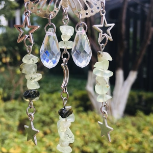 Detail view of silver butterfly suncatcher with star charms and prism crystals