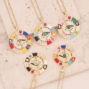 Gold evil eye pendant necklace with colorful enamel and zircon crystals on stone