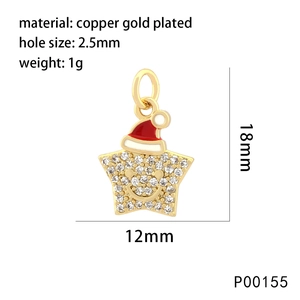 Macro view of gold-plated star pendant with cubic zirconia and a red Christmas hat