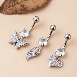 Detailed shot of steel navel rings with butterfly, wing and heart zircon charms