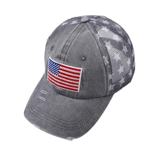 Close-up of distressed brim and American flag embroidery on a mesh baseball cap