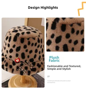 Detail view of leopard print plush bucket hat with red apple embroidery and bow accent