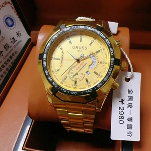 Detail view of the Oruss gold-plated chronograph watch in a brown leather box