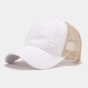Detailed macro shot of white distressed cotton canvas and khaki mesh trucker hat