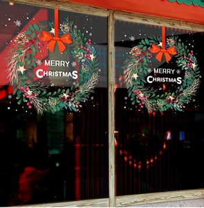 Detail of static Christmas wreath window stickers with Merry Christmas text on glass