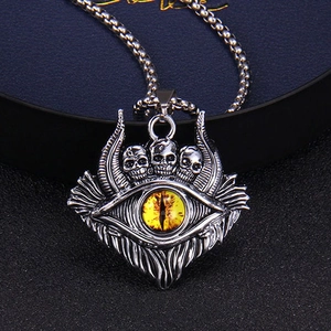 Macro detail of gothic skull pendant with yellow evil eye and vintage metal texture