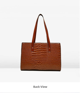 Rear view of large dark brown crocodile embossed tote bag with dual shoulder straps