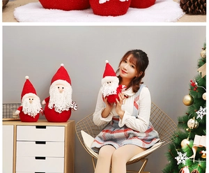 Detail of plush Santa Claus dolls in red and white soft fabric for Christmas decor