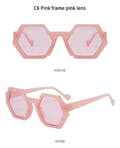 Detailed close-up of pink hexagonal sunglasses with resin frames and tinted lenses