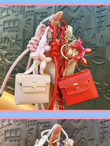 Mini leather bag keychain cute charm with balloon dog pendant and strap for keys or bag decor.