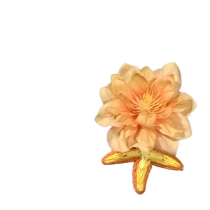 Elegant beige fabric flower hair clip with embroidered base and delicate petal layers