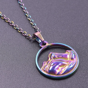 Macro shot of 18K gold mountain pendant with iridescent colorful metallic finish
