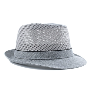 Macro detail of breathable mesh knit texture on a light gray summer fedora hat