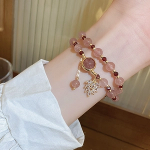 Macro shot of double-layer strawberry quartz and garnet beaded bracelet on wrist