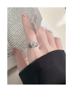 Detailed close-up of S925 silver ring featuring colorful zircons and oval opal on a finger