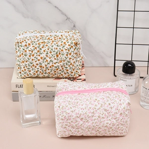 Floral quilted cotton makeup bags with zippers shown in a stylish travel arrangement