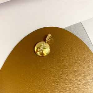 Macro detail of 18K gold plated letter I pendant with sparkling pavé cubic zirconia