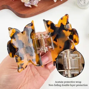 Handheld butterfly hair claw made of tortoiseshell acetate with durable metal spring buckle