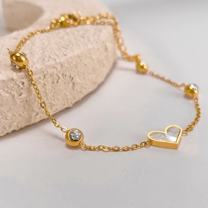 Elegant gold titanium heart bracelet with mother of pearl inlay and sparkling zircon charms