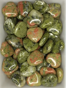 Close-up of heart-shaped unakite stones showing polished green and pink textures