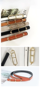 Close-up of double-ring gold buckle and cross-textured leather on thin commuter belt