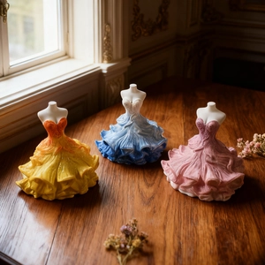 Macro detail of elegant dress-shaped candle molds in yellow, blue, and pink resin