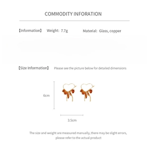 Detailed spec sheet showing 6cm glass bow heart earrings with 7.7g weight info