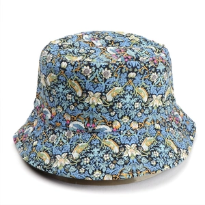 Detail of blue sun hat with floral and bird print patterns on durable cotton canvas